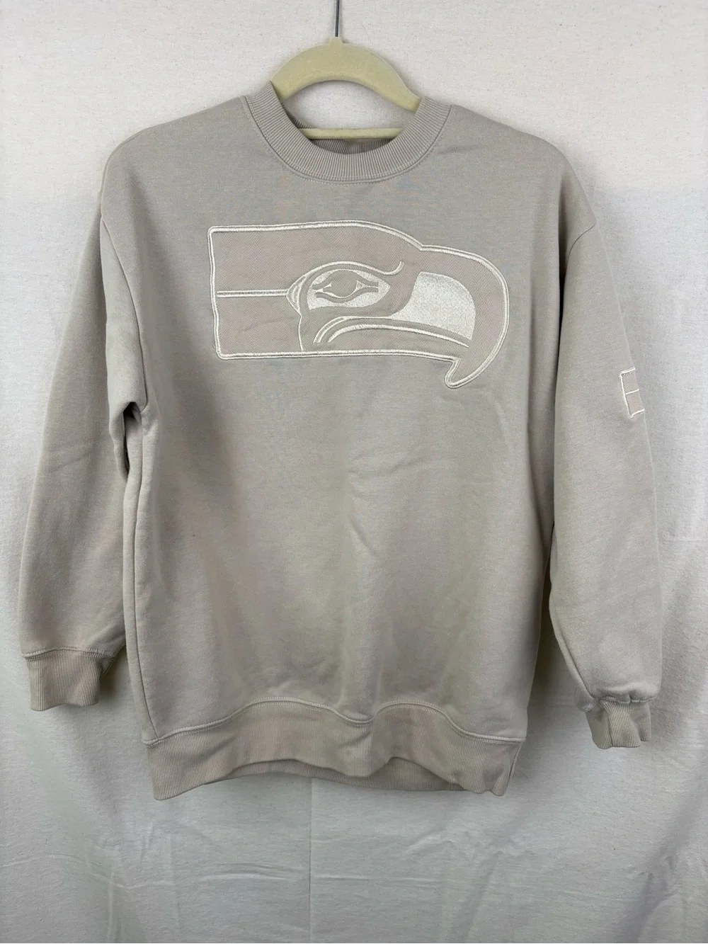 NFL unisex Crewneck Sweatshirt in Light Taupe with Embroidered Logo
